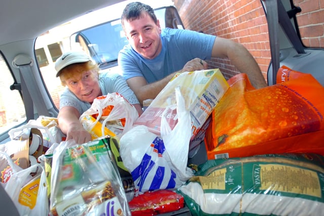 The Cathedral Breakfast and Archers Projects, Project Manager Tim Renshaw and cook Maggie Durand sorting out the donations for The Family Life Centre on Nursery Street in 2005