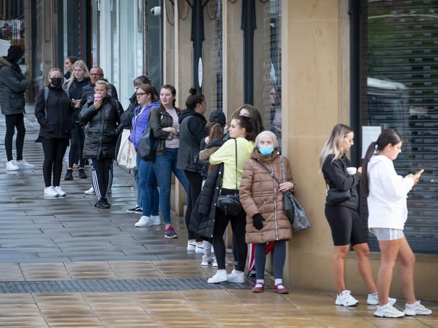 People queue outside the Primark store on Princes Street in Edinburgh, which reopens today as part of Scotland's phased plan to ease out of the coronavirus pandemic lockdown.