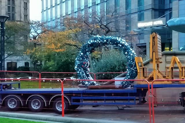 Festive fixtures are being moved into place, including giant baubles and presents made of string lights, a huge Christmas wreath and a banner.