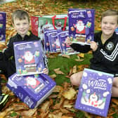 Lucas Clack and Luey Waterfall from Abbey Lane FC under 8's with some of the advent calenders they are donating to The Grace Foodbank in Lowedges