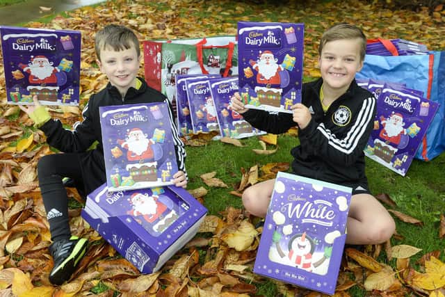 Lucas Clack and Luey Waterfall from Abbey Lane FC under 8's with some of the advent calenders they are donating to The Grace Foodbank in Lowedges