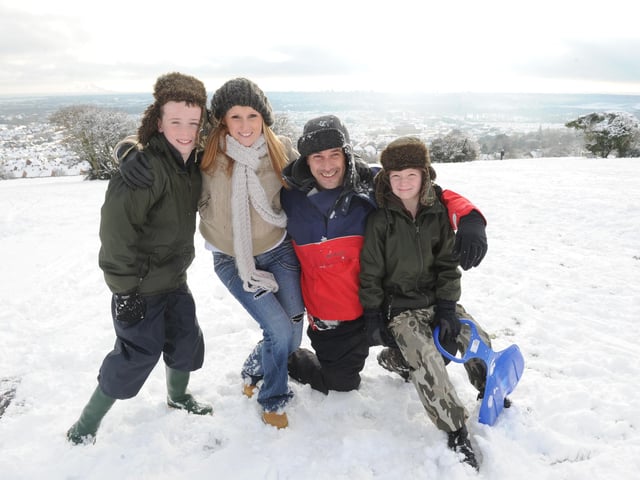 Kevin Bartholemew and Keri Clarke from Portsmouth enjoy the snow on Portsdown Hill with their children (left), Harry (10), and Oliver (seven).