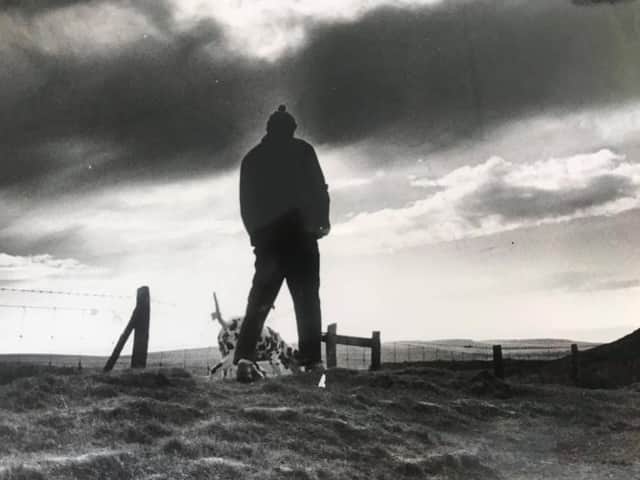 A man walking his dog on the Ringlow to Hathersage Road with Higger Tor to the right in the background - December 1977