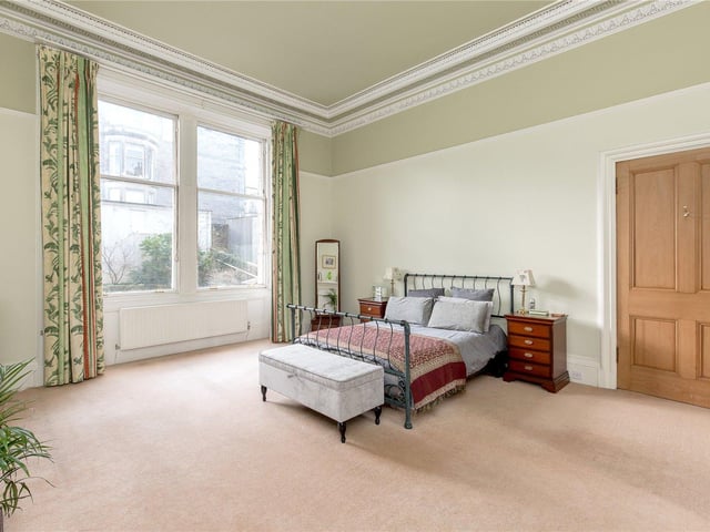 The flat boasts four double bedrooms, such as this master bedroom you can see here. There is also two kitchens, three bathrooms and a light and airy study which leads straight into the garden
