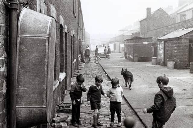 Children play football lin the street in 

April 15th 1971