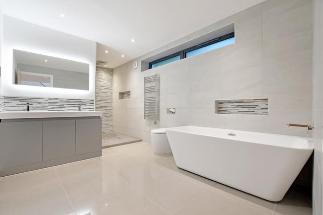 This is the family bathroom - it has under floor heating, two wash hand basins, a Mode bath and a wet room-style shower area with a fitted rain head shower.