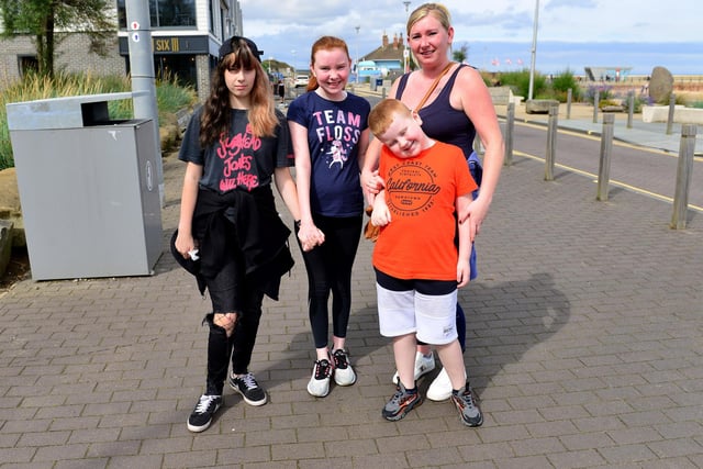 From left to right, Scarlett Porter, Sophia and Heather Sutherland with Jake Dewar stop for a photograph as they walk along the sea front at Roker.