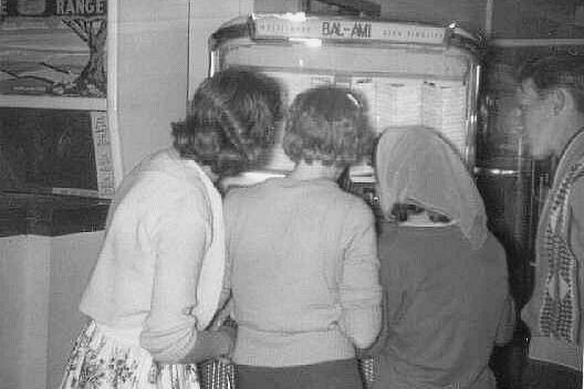 Girls gather round the juke box at the South Shields fairground.