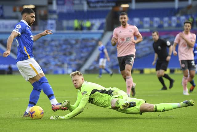 Sheffield United's English goalkeeper Aaron Ramsdale, right, saves the ball from Brighton's Alireza Jahanbakhsh (Mike Hewitt/Pool via AP)