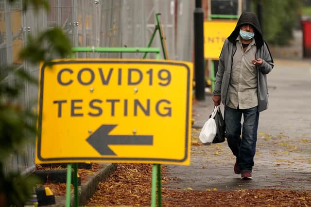 A man walks past a Covid-19 testing site  (Photo by Christopher Furlong/Getty Images)