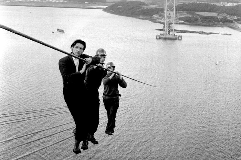 Men fearlessly walk ropes during construction of the Forth Road Bridge, August 2 1961.