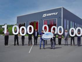 Gripple chairman Hugh Facey (right centre), global managing director Ed Stubbs, UK managing director Kevin St Clair, and operations director Charlotte Hill, with current and former employees celebrating the company’s one billionth fastener outside the company’s Riverside Works factory in Sheffield.