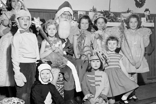 Santa Claus with children in fancy dress costumes at Davidsons Mains Church in 1962.