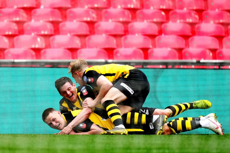 Hebburn Town's Oliver Martin (bottom) celebrates scoring their side's third goal of the game with team-mates during the Buildbase FA Vase 2019/20 Final at Wembley Stadium, London. Picture date: Monday May 3, 2021.