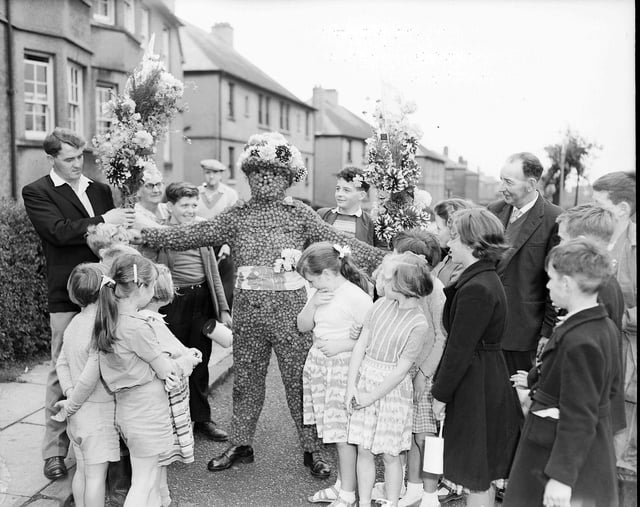 The Burryman Mr J Hast leaves his home to go round the town in his fancy dress at the Queensferry Fair in August 1960.