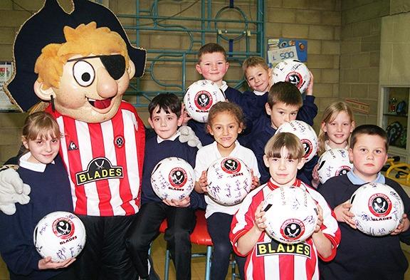 Some of the pupils of Intake School pictured with Captain Blade after taking part in a penalty shoot out in aid of charity, on February 4, 2000