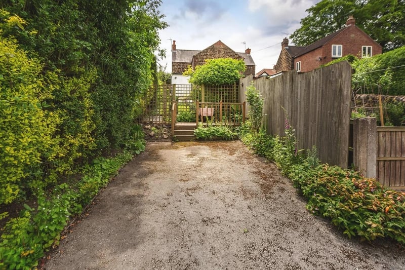The lawned rear garden leads to a decked seating area and this in turn leads to a Tarmac car standing area accessed via a side shared driveway.