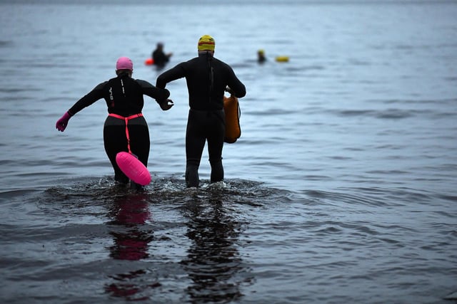 Open water swimming enthusiasts enjoy an early morning swim in Loch Lomond,Trossachs, Scotland. A new study from the UK Dementia Research Institute found that the blood of regular winter swimmers contains a "cold-shock" protein that wasn't found in that of people who did other cold-weather exercise on dry land.