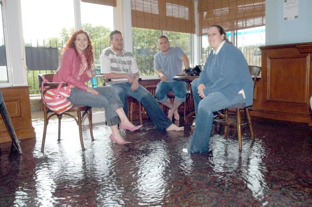 Mansfield Early Doors Manager Jemma Knight, right, waits for the flood to go down in 2007. 
Also pictured from the left are: Katie Townsend, Graham Betts and Carl Beet.