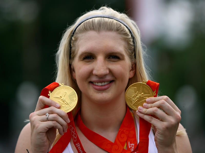 Rebecca Adlington shows off her two Olympic gold medals outside the Athletes Village.