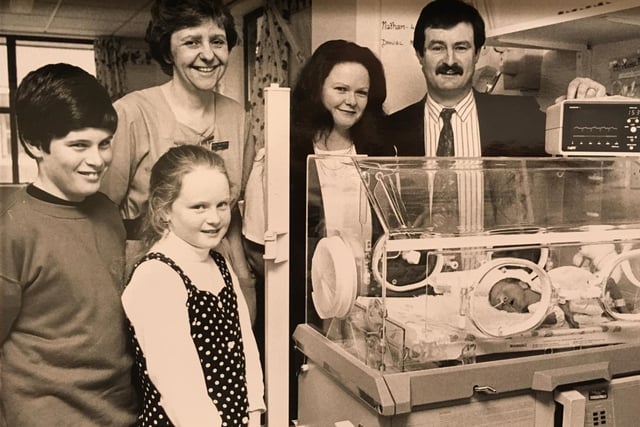 This picture from February 1994 shows Ken and Pamela Wilson and their children Kieran and Hayley presenting an ECG monitor from the charity BLISS to sister Hazel McKinnell at the Special Baby Care Unit. The baby inside the incubator is Daniel Opie.