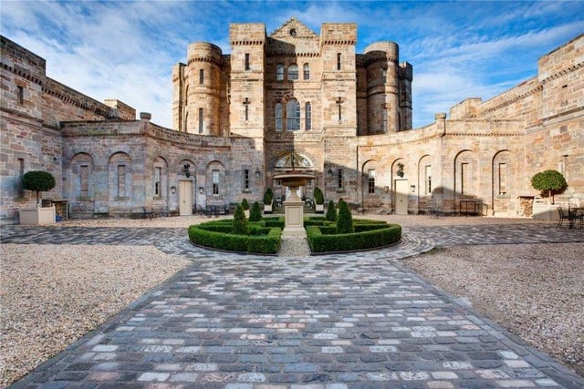 The parterre courtyard is the perfect place to admire the external castellated features of the property, including the slit windows, turrets and period sandstone and limestone.