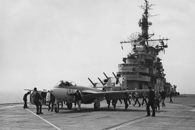 A Royal Navy Fleet Air Arm Hawker Sea Hawk jet fighter prepares to conduct take off and landing drills from the angled flight deck of the United States Navy Essex-class aircraft carrier the USS Antietam (CV-36) on 3 July 1953.