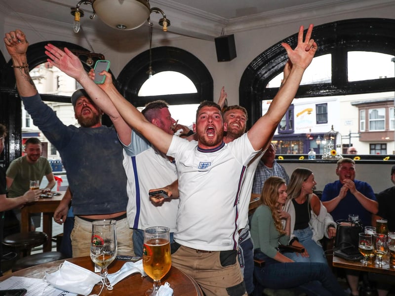Fans pictured in The Kings pub celebrating as England score their first goal. Picture: Stuart Martin (220421-7042)