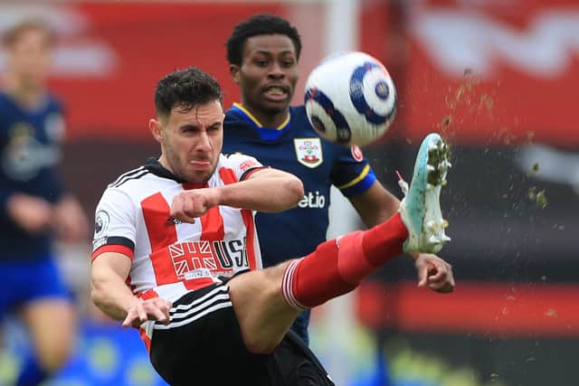 Sheffield United's English defender George Baldock (L) clears from Southampton's English midfielder Nathan Tella (R)  (Photo by MIKE EGERTON/POOL/AFP via Getty Images)