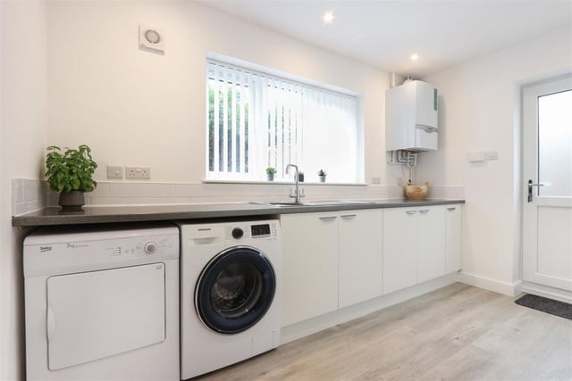 The well-appointed utility room, containing the heating boiler, is separate to the kitchen.