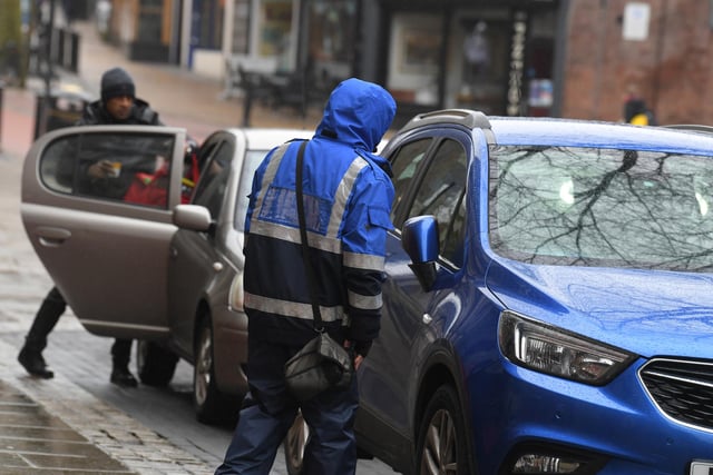 A parking enforcement officer on patrol in Preston, where nearly 2,500 tickets were issued across just five streets in 2020/21 (image: Neil Cross)