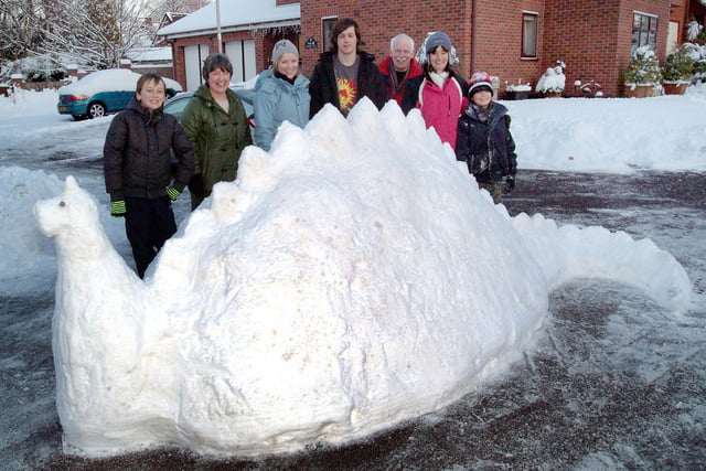 Creators of a snow stegasaurus on Woodview Gardens, Forest Town, show off their handy work.  The residents who included Jill and Henry Poole, Morgan and Jake Beet, Ken and Rosie Daley and Debbie Williamson made the sculpture following heavy snowfall ten years ago