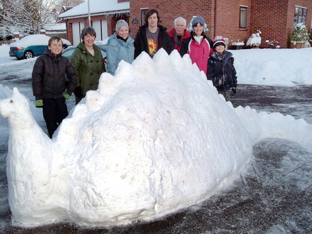 Creators of a snow stegasaurus on Woodview Gardens, Forest Town, show off their handy work.  The residents who included Jill and Henry Poole, Morgan and Jake Beet, Ken and Rosie Daley and Debbie Williamson made the sculpture following heavy snowfall ten years ago