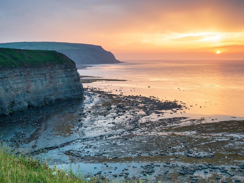 A historic fishing village tucked into a hillside, offering a maze of narrow streets and a sheltered harbour. It’s a photographer's dream in the winter light, famously known for its association with Captain Cook. 🕒 ~1 hour 40 mins