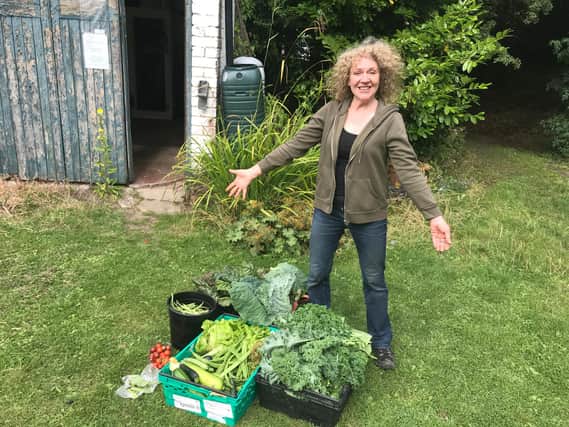 Sharon, a volunteer with some of the fresh vegetables grown by the group.