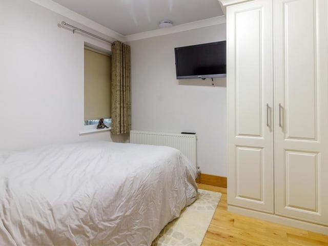 Here is the second bedroom, which is compact but still boasts a high-quality, modern fitted wardrobe with hanging rail, shelving and 'soft close' doors. The room also benefits from a radiator, solid oak floor, coving to the ceiling and a telephone point. The third bedroom, which is slightly bigger, is currently being used as an office.