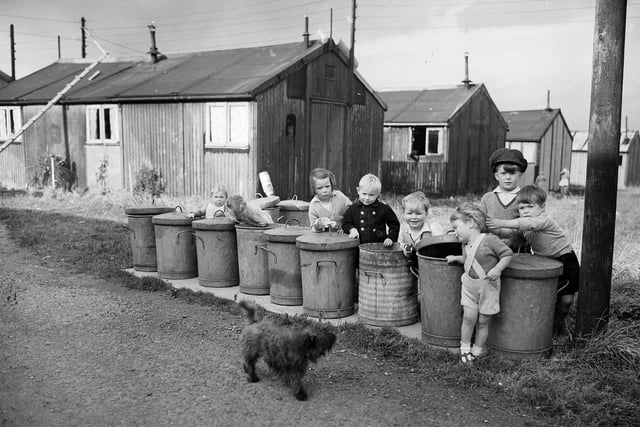 Sighthill Camp Edinburgh  Children playing at the line of rubbish bins, 1954.