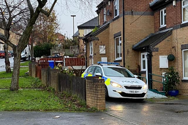 A police car remains outside the property where the woman was found dead in Castlebeck Drive.