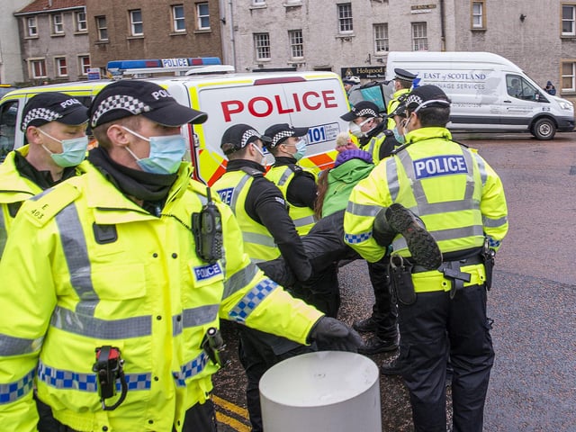 One had to be carried by officers into the back of a waiting police van.