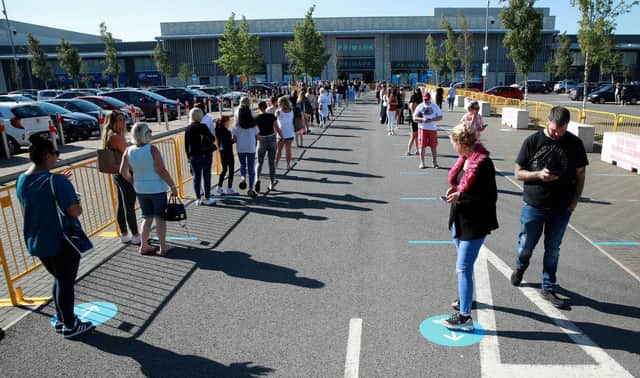 Thousands of shoppers were seen queuing for reopened shops in England
