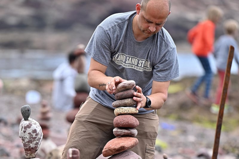 This competitor takes care to build his masterpiece at the European Stone Stacking Championships.