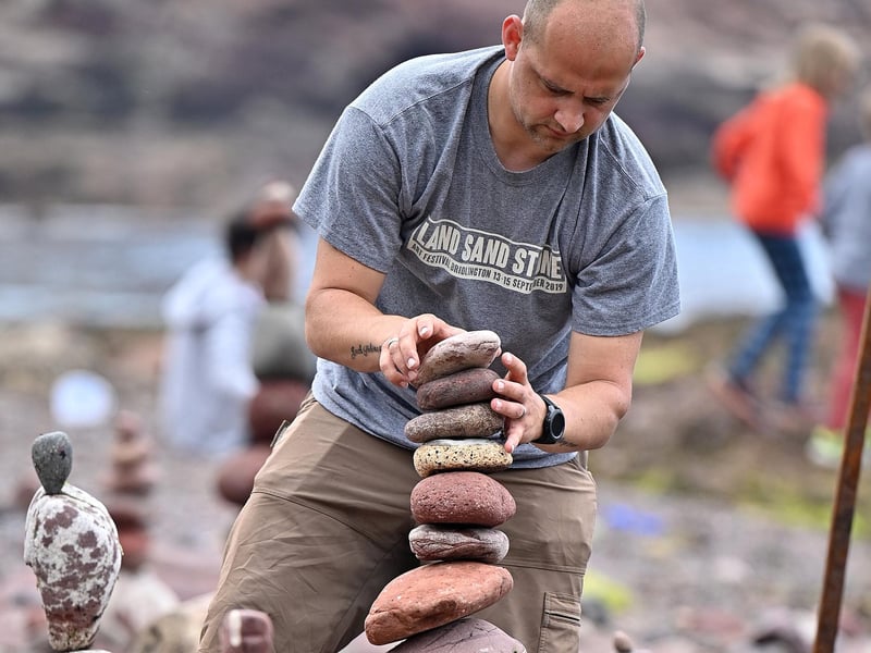 This competitor takes care to build his masterpiece at the European Stone Stacking Championships.