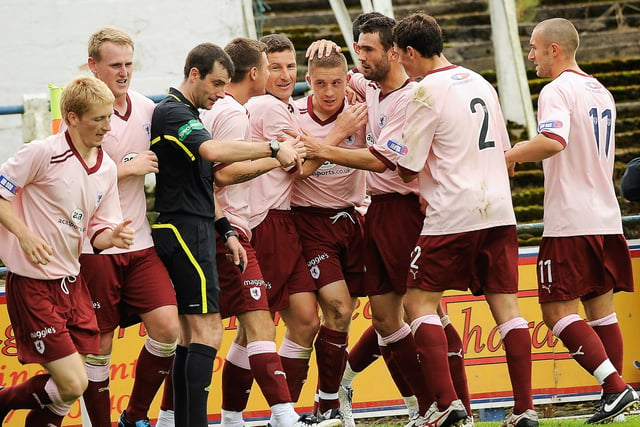 John Baird is mobbed by his team-mates after scoring in this away win from August 2011.