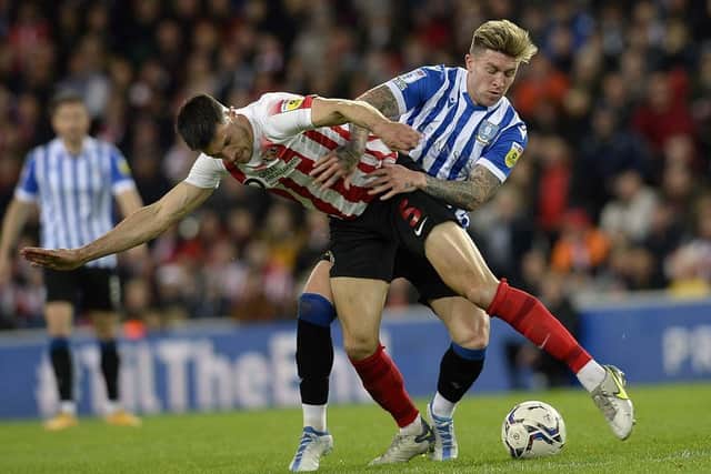 Sheffield Wednesday substitute Josh Windass takes on Sunderland's Danny Batth in the first leg at the Stadium of Light.