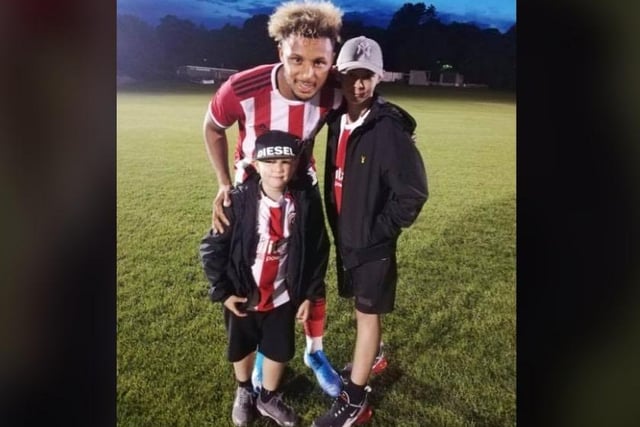 Thirteen-year-old Tyler and Harrison, eight, with Blades striker Lys Mousset.