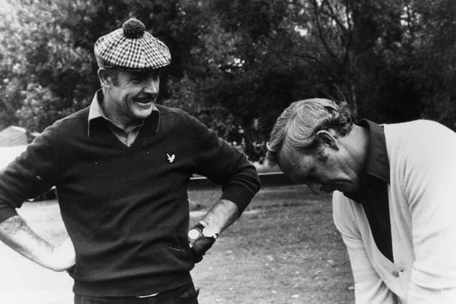 15th October 1976:  Film star Sean Connery gets a few tips from American golfer Arnold Palmer, his partner in a Pro-Am tournament in Paris.