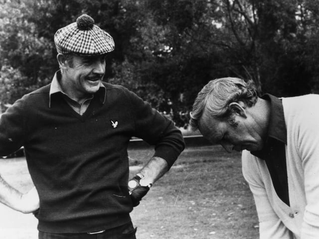 15th October 1976:  Film star Sean Connery gets a few tips from American golfer Arnold Palmer, his partner in a Pro-Am tournament in Paris.