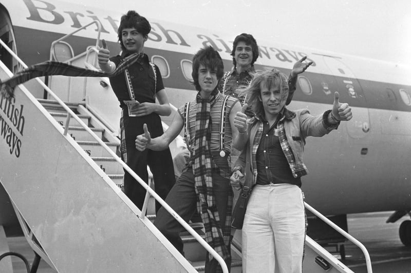 Bay City Rollers members Ian Mitchell, Les McKeown, Stuart Wood  and Derek Longmuir board a plane at Edinburgh airport for a promotional tour of the USA in April 1976