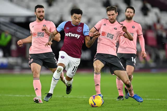 Jesse Lingard of West Ham United takes on Chris Basham of Sheffield United and Enda Stevens of Sheffield United. (Photo by Justin Setterfield/Getty Images)