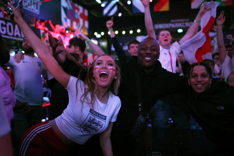 England fans cheer at BOXPARK Croydon as they watch a live broadcast of the semi-final match between England and Denmark.
